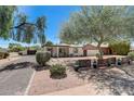 Inviting home with mature trees, decorative metal fencing, and desert landscaping for a unique curb appeal at 1701 W Clarendon Ave, Phoenix, AZ 85015