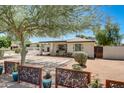 A delightful desert-landscaped front yard featuring decorative metal fencing and pavers that create a visually appealing space at 1701 W Clarendon Ave, Phoenix, AZ 85015