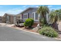 Cozy home featuring a golf cart, landscaping, and palm trees at 17200 W Bell Rd # 1748, Surprise, AZ 85374