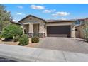 Charming home exterior with a well-maintained front yard and a two-car garage at 18225 N 66Th Way, Phoenix, AZ 85054