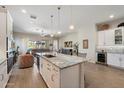 Open concept kitchen featuring a large granite island, stainless steel appliances, and modern white cabinetry at 18225 N 66Th Way, Phoenix, AZ 85054