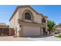 The home's front elevation reveals its two-story design, a large garage, and appealing architectural elements at 23119 W Papago St, Buckeye, AZ 85326