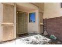 Covered entryway features a secure screen door, a window for natural light, and stone decorations at 23119 W Papago St, Buckeye, AZ 85326