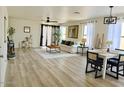 Bright living room featuring an open floor plan and light wood floors, complemented by neutral decor and ample natural light at 2358 E Peach Tree Dr, Chandler, AZ 85249