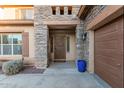 Close up of stone accented entrance, with a detailed front door, and a charming welcome mat at 26529 N 167Th Ave, Surprise, AZ 85387