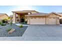 Inviting home showcasing a three-car garage, desert landscaping, and a tiled roof at 30026 N 47Th St, Cave Creek, AZ 85331