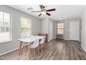 Bright dining area features modern table set, fan, and wood-look flooring at 3020 E Megan St, Gilbert, AZ 85295