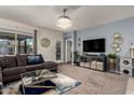 Comfortable living room features a plush sectional sofa, modern decor, and sliding door at 30962 W Weldon Ave, Buckeye, AZ 85396