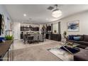 Open-concept living space with a seamless transition from the living room to the dining and kitchen areas at 30962 W Weldon Ave, Buckeye, AZ 85396