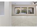 Bright living room showcasing large windows, tile floors, and views of the backyard at 3551 W Hidden Mountain Ln, Anthem, AZ 85086