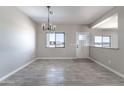 Dining room features wood-look tile flooring, chandelier and natural light at 3887 S 331St Ave, Tonopah, AZ 85354