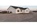 New construction home with white exterior, covered patio, and a large yard at 3880 S 331St Ave, Tonopah, AZ 85354