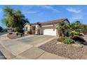 Beautiful home with desert landscaping, a two-car garage, and a driveway leading to the house at 4208 E Indigo St, Gilbert, AZ 85298