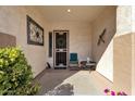 Cozy front porch with seating, decorative art, and a welcoming atmosphere for visitors at 4208 E Indigo St, Gilbert, AZ 85298