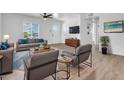 Bright living room with modern furnishings, ceiling fan, and hardwood flooring at 437 W 6Th Pl, Mesa, AZ 85201