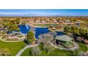 Scenic aerial view of a Primary-planned community with a lake, golf course, and park at 44328 W Knauss Dr, Maricopa, AZ 85138