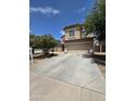 Beautiful home featuring a large driveway and well-manicured trees in the front yard at 44328 W Knauss Dr, Maricopa, AZ 85138