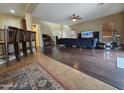 Spacious living room with wood floors, comfortable seating, and a bright, open layout at 44328 W Knauss Dr, Maricopa, AZ 85138
