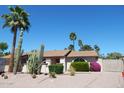 Charming exterior elevation of a single-story home with desert landscaping, and mature palm and Saguaro cactus at 4442 E Redfield Rd, Phoenix, AZ 85032