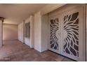 Front entrance with a decorative metal security screen, tile flooring, and neutral stucco exterior at 4442 E Redfield Rd, Phoenix, AZ 85032