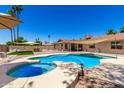 Backyard swimming pool and spa with desert landscaping and a covered patio at 511 E Carter Dr, Tempe, AZ 85282