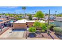 Aerial view of the property highlighting landscaping, two-car garage, and residential neighborhood at 6401 N 82Nd Way, Scottsdale, AZ 85250