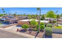 Charming home with desert landscaping, mature trees, and a spacious driveway at 6401 N 82Nd Way, Scottsdale, AZ 85250