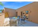 Private outdoor patio with a table, chairs, and access to the home through elegant French doors at 6401 N 82Nd Way, Scottsdale, AZ 85250
