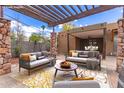 Stylish outdoor patio with comfortable seating, pergola, and an inviting ambiance for relaxation at 7726 E Kimsey Ln, Scottsdale, AZ 85257