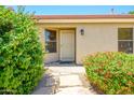 Charming front entrance with lush landscaping, stone pathway and security door at 8331 E Plata Ave, Mesa, AZ 85212
