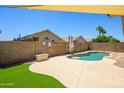 Relaxing backyard pool area with artificial turf and secure brick fence at 8331 E Plata Ave, Mesa, AZ 85212