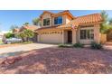 Charming two-story home featuring a desert landscape and a welcoming two car garage at 8845 E Larkspur Dr, Scottsdale, AZ 85260