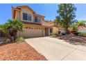 Beautiful two-story home featuring a two-car garage and desert landscape at 8845 E Larkspur Dr, Scottsdale, AZ 85260
