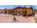 Front exterior of a charming brick home with low-maintenance desert landscaping and mature succulents at 962 S Main Dr, Apache Junction, AZ 85120