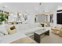 Bright open-concept living room featuring a large white sectional, modern lighting and decor at 11116 N 78Th St, Scottsdale, AZ 85260