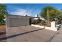 Single-story home featuring desert landscaping, an attached two-car garage and a concrete driveway at 1302 E Nicolet Ave, Phoenix, AZ 85020