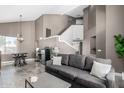 Modern living room featuring high ceilings, stylish decor, and tiled floors at 1721 W South Fork Dr, Phoenix, AZ 85045