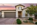 Charming single-Gathering home featuring a well-manicured front yard and a two-car garage at 18025 N 65Th Pl, Phoenix, AZ 85054