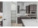 Well-equipped kitchen showcasing stainless steel appliances and a convenient pantry at 18025 N 65Th Pl, Phoenix, AZ 85054