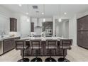 Contemporary kitchen featuring a large island with seating and stylish pendant lighting at 18025 N 65Th Pl, Phoenix, AZ 85054