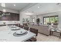 Inviting open-concept living space with a modern kitchen, dining area, and comfortable seating at 18025 N 65Th Pl, Phoenix, AZ 85054