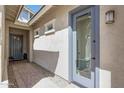 Covered front entry with beautiful stonework and complementary grey trim surrounding the front door at 18166 W Hope Dr, Goodyear, AZ 85338