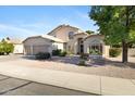 Beautiful two-story home with desert landscaping, a three-car garage, and well-manicured front yard at 1975 E Chilton Dr, Tempe, AZ 85283