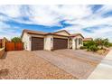 Beautiful house showing its three-car garage, brick driveway, and desert landscaping at 19858 W San Juan Ave, Litchfield Park, AZ 85340
