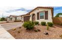 Stylish single Gathering home showing a brick driveway and desert landscaping with an ornamental front door at 19858 W San Juan Ave, Litchfield Park, AZ 85340