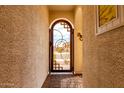 Exterior shot showcasing the decorative steel entry gate with stone surround at 19858 W San Juan Ave, Litchfield Park, AZ 85340