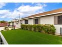 Home exterior with lush artificial turf and a modern black metal fence enclosing the backyard space at 2242 E Palm Ln, Phoenix, AZ 85006
