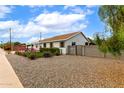 A cozy one-story home surrounded by a beautiful gravel landscape with lush greenery at 2242 E Palm Ln, Phoenix, AZ 85006