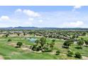 Expansive aerial view of the community and golf course with mountains in the distance at 23077 S 214Th St, Queen Creek, AZ 85142
