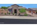 Charming single-story home featuring stone accents, manicured landscaping, and a welcoming front entrance at 25449 N 102Nd Dr, Peoria, AZ 85383